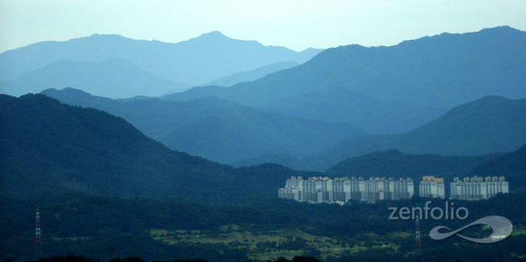high rises dwarfed by mountains